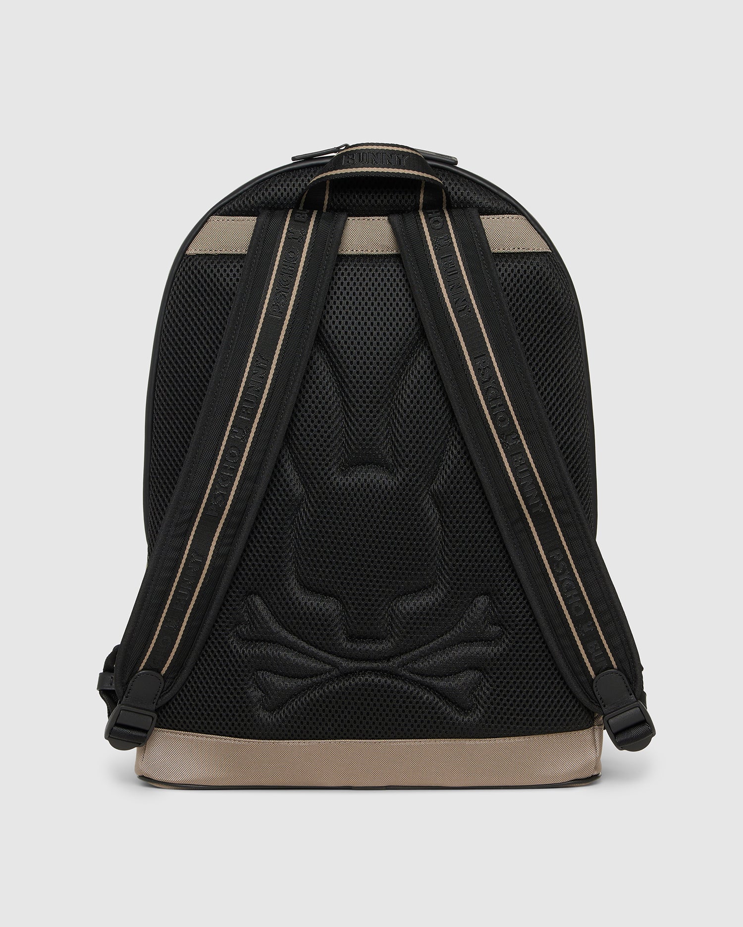 A stylish black urban backpack with a subtle rabbit and crossbones design embossed on the back panel. The straps are black with beige accents, and the base is beige. With a sleek, modern appearance and a padded laptop compartment, this Psycho Bunny MENS DOME BACKPACK - B6A628Z1BP blends functionality with unique style seamlessly.
