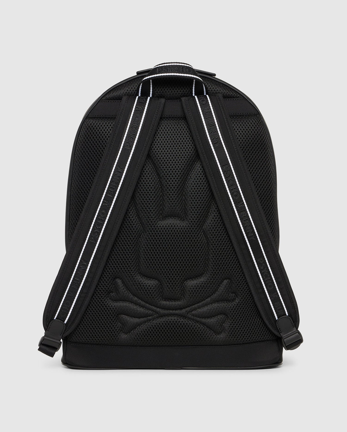 A black DOME BACKPACK - B6A628Z1BP by Psycho Bunny featuring a mesh design with a reflective Batman logo and reflective stripes on the shoulder straps, against a solid gray background.