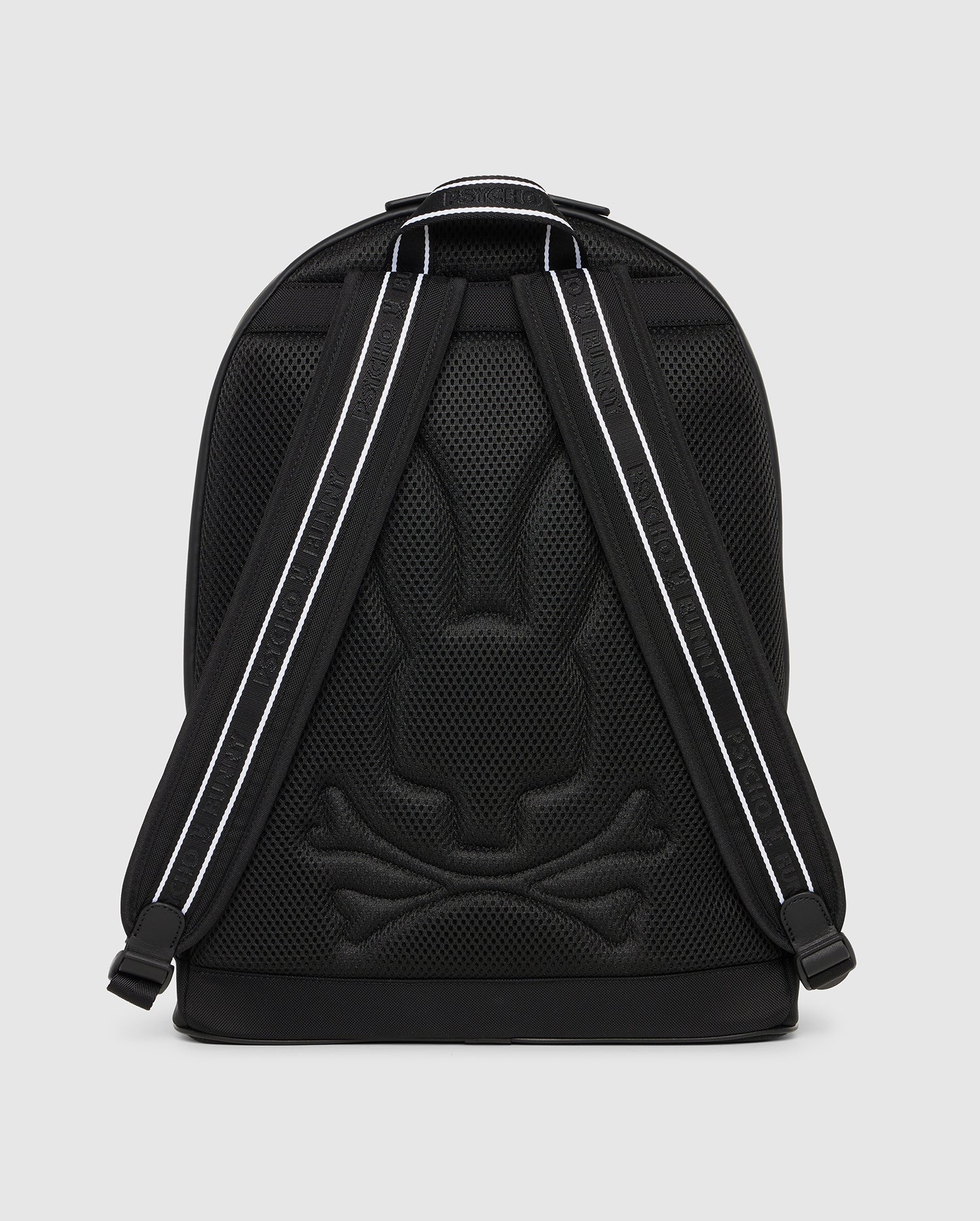 A black DOME BACKPACK - B6A628Z1BP by Psycho Bunny featuring a mesh design with a reflective Batman logo and reflective stripes on the shoulder straps, against a solid gray background.
