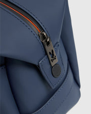 Close-up of the Psycho Bunny MENS TOILETRY KIT - B6A636F200 in blue, crafted from 100% polyester. It features a black zipper with orange teeth, equipped with a round black pull tab adorned with a small rabbit logo to keep your essentials organized on the go.