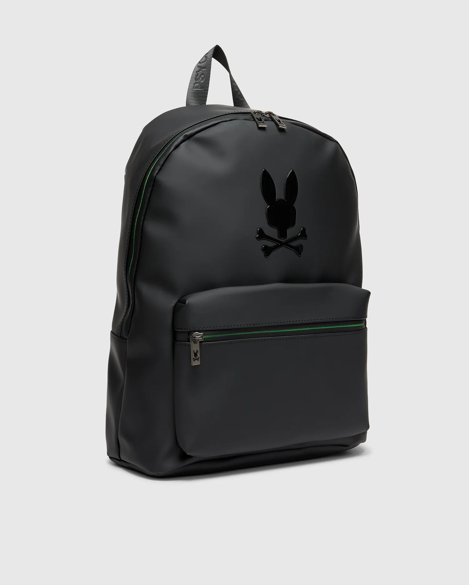 The MENS RUBBERIZED BACKPACK - B6A637F200 by Psycho Bunny features a minimalist black design with a front zippered pocket. It showcases a stylized rabbit with crossbones logo on the front, crafted from smooth material for durability, and sleek zippers against a plain gray background.