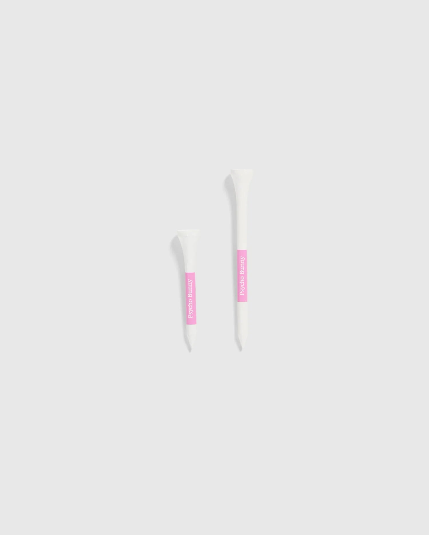 The image features two white tubes set against a light gray background, each with a pink label. The smaller tube is positioned on the left and is decorated with Psycho Bunny's 75 PACK GOLF TEES - B6A659C200, accented by bunny-themed designs. The larger tube is on the right, ideal for those looking for whimsical golf accessories from the Psycho Bunny brand.