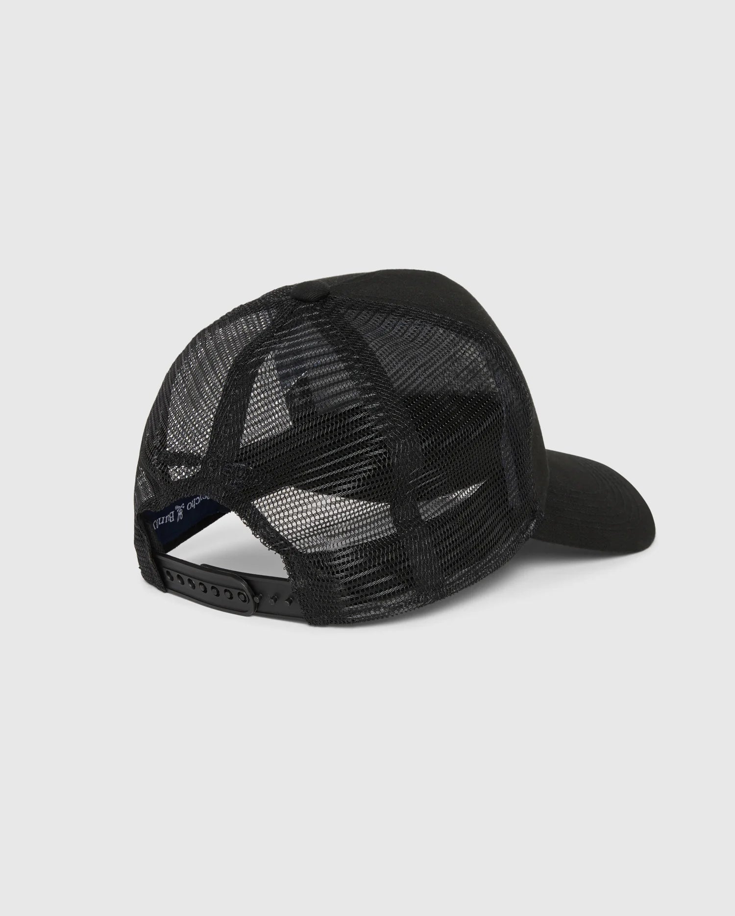 The MENS MALTON TRUCKER CAP - B6A797D200 by Psycho Bunny, viewed from the back, showcases a black mesh construction with a curved brim and an adjustable snapback closure. Crafted from 100% cotton mesh, it offers exceptional ventilation. The solid front panel enhances durability against the plain white background.