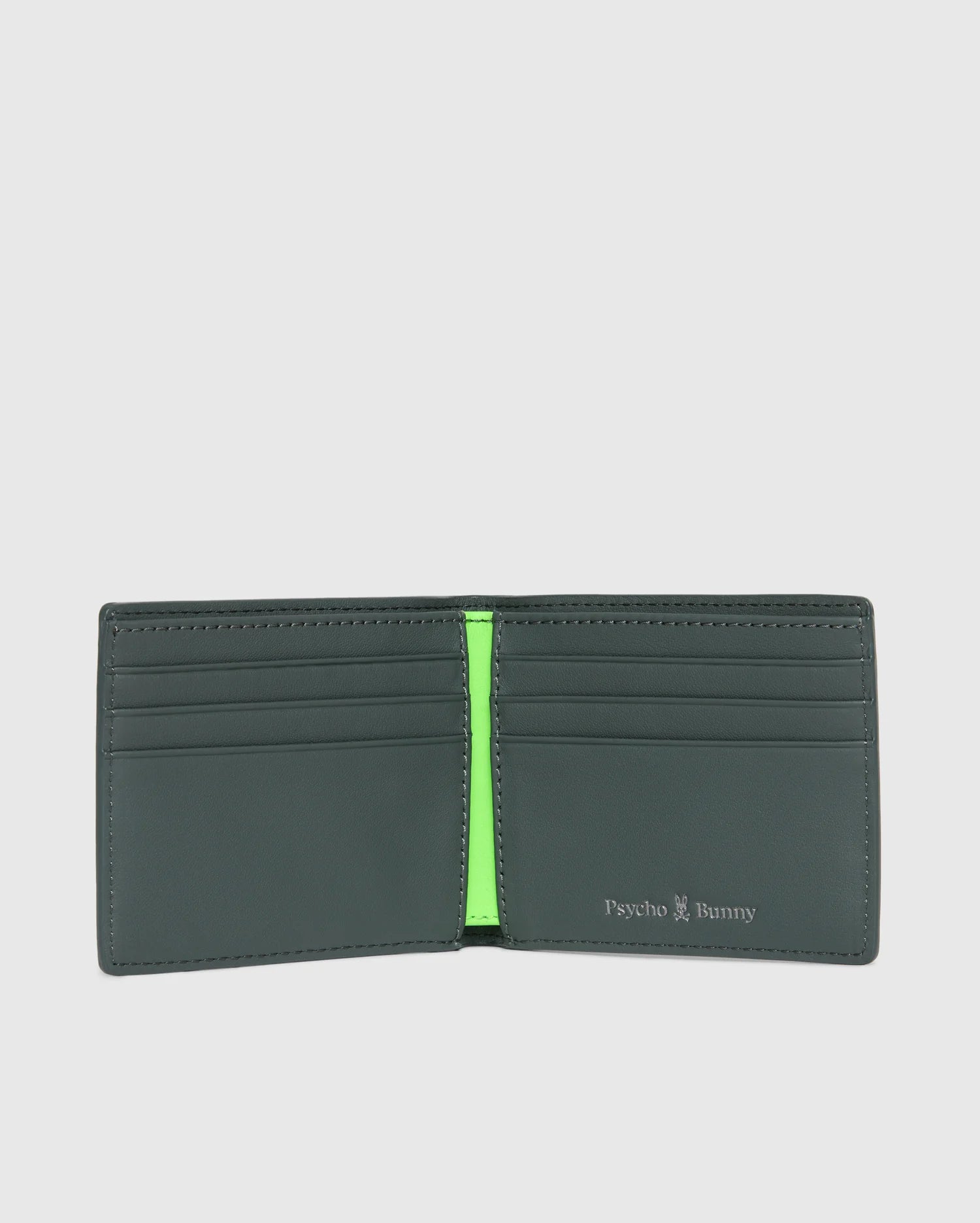 This fashionable MENS WORDMARK LEATHER WALLET - B6A868D200 by Psycho Bunny features a sleek black leather exterior that opens to showcase its chic interior design. It includes multiple card slots and a striking bright green section. The brand name "Psycho Bunny" is proudly embossed on the right, adding a distinctive touch of style to this men's leather wallet.