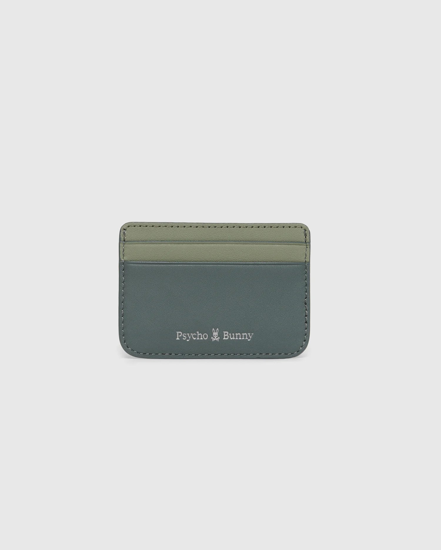 The MENS WORDMARK LEATHER CARD CASE - B6A869D200 by Psycho Bunny is crafted from durable shell pebble leather in two shades of green. It features the brand name and a small white logo at the bottom, ideal for organizing any man's essentials.