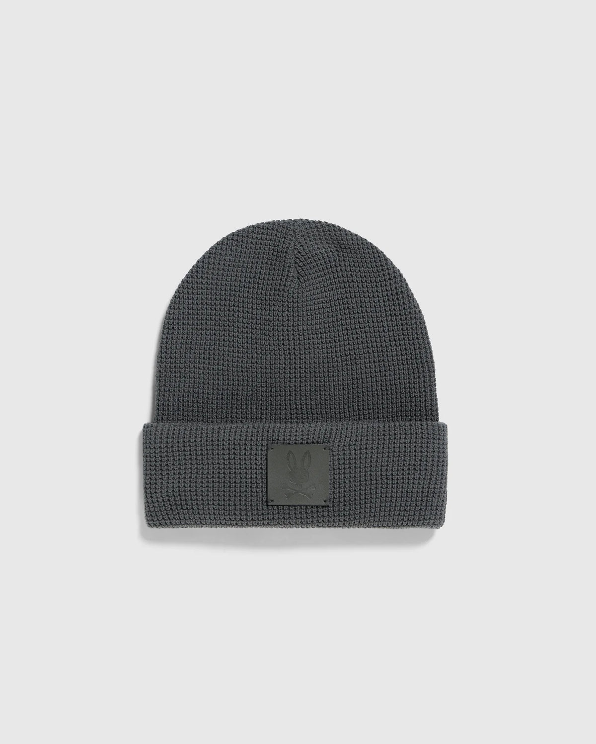 A Psycho Bunny MENS WAFFLE BEANIE, model B6A873D200, in gray, featuring a cuff and a small embossed patch on the front, is shown on a plain white background.