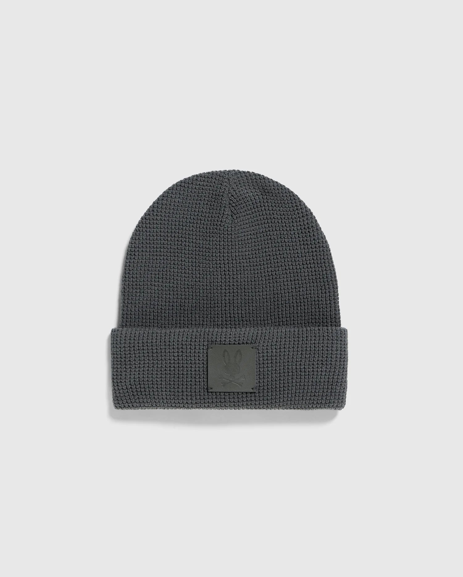 A Psycho Bunny MENS WAFFLE BEANIE, model B6A873D200, in gray, featuring a cuff and a small embossed patch on the front, is shown on a plain white background.