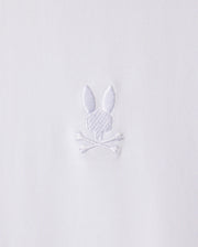 The MENS ARTHUR JERSEY SHIRT - B6C748D200 by Psycho Bunny is made from white jersey fabric and features a discreet embroidered design of a bunny head atop two crossed bones.