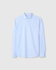 The Psycho Bunny MENS BRENDAN JERSEY SHIRT - B6C749D200 is a light blue button-up shirt with long sleeves and a crisp collar, featuring an embroidered chest Bunny logo. Made from soft Pima cotton, the shirt is neatly pressed and displayed against a plain background.