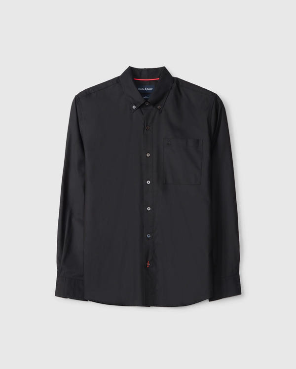 The Psycho Bunny MENS JARED COTTON MODAL SHIRT (B6C774D200) is a black long-sleeve button-up with a collar and chest pocket, crafted from soft modal fabric. It features a simple design with red stitching detail on the second buttonhole.