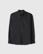 The Psycho Bunny MENS JARED COTTON MODAL SHIRT (B6C774D200) is a black long-sleeve button-up with a collar and chest pocket, crafted from soft modal fabric. It features a simple design with red stitching detail on the second buttonhole.