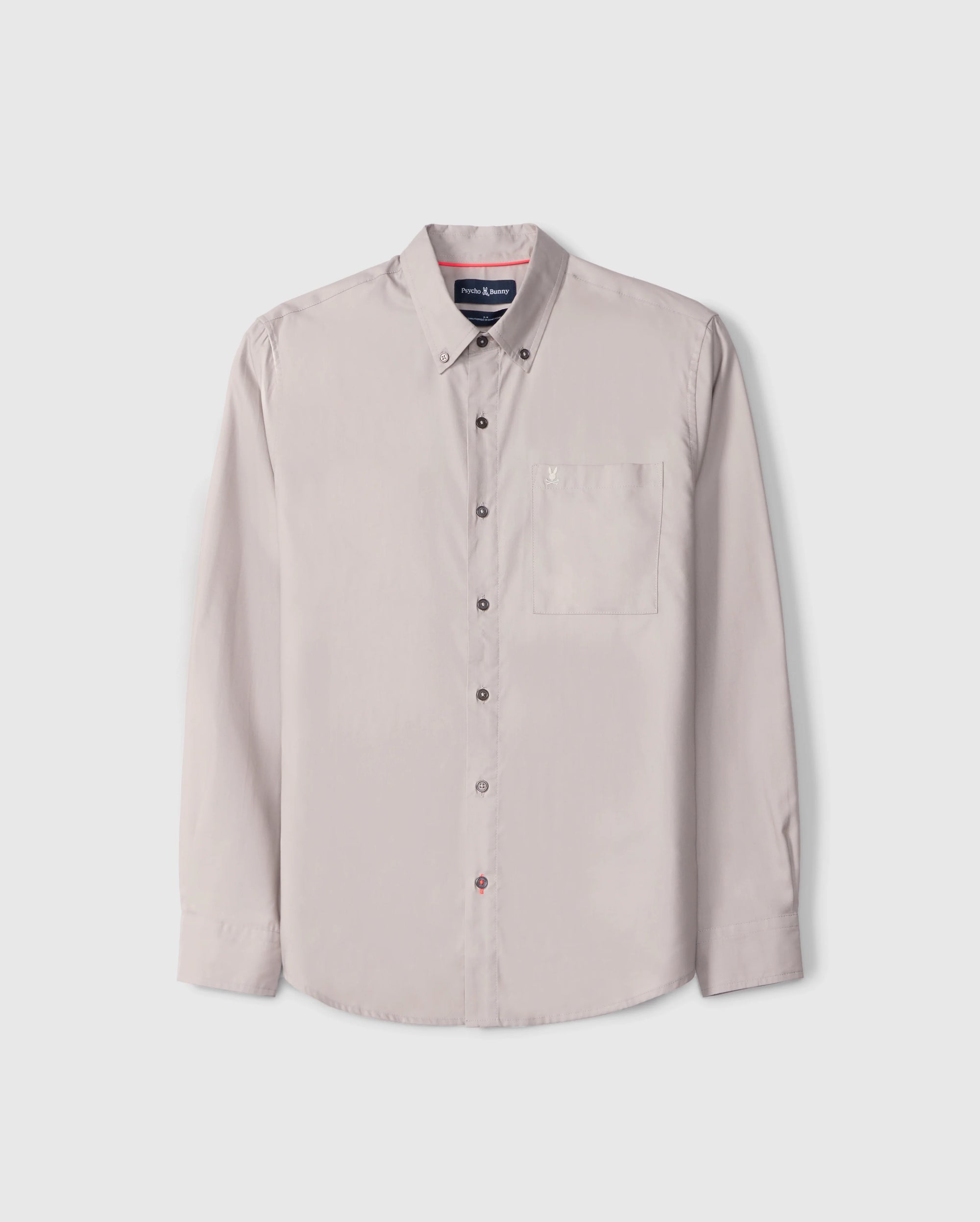 The Psycho Bunny MENS JARED COTTON MODAL SHIRT (B6C774D200) is a beige shirt featuring long sleeves, a button-up closure, collar, and front chest pocket. Crafted from premium cotton-modal blend and displayed on a plain white background, it exemplifies timeless style and comfort.