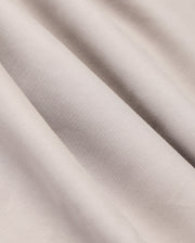 The MENS JARED COTTON MODAL SHIRT by Psycho Bunny features light grey, textured fabric with soft diagonal folds and subtle shadows, highlighting its smooth, slightly shiny surface reminiscent of a premium cotton shirt.