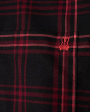 Close-up of the MENS HAYES PLAID SHIRT - B6C842D200 by Psycho Bunny, a black and red plaid shirt crafted from soft Pima cotton, featuring a small embroidered design with a playful bunny ears and crossbones motif in red.