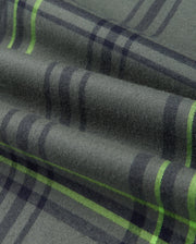 Close-up of the Psycho Bunny MENS HAYES PLAID SHIRT (B6C842D200) highlighting its premium design in green plaid fabric featuring dark and light lime green stripes. The soft Pima cotton provides visible texture and subtle folds, making it perfect for a stylish men's plaid shirt look.