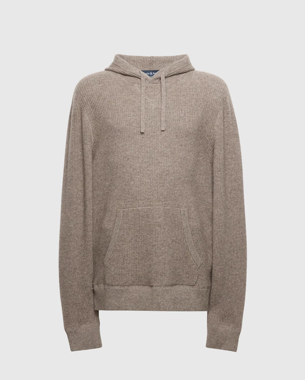 The MENS LEVAN WAFFLE HOODED SWEATER - B6E246E200 by Psycho Bunny is a beige knitted hoodie with a front pocket, drawstring hood, and textured weave using cozy wool-cashmere blend. An embroidered chest bunny adds charm, ideal for casual or cool weather.