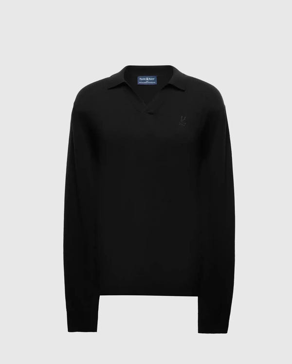 The Men's Johnny Collar Sweater - B6E258E200 by Psycho Bunny is crafted from a cotton-wool blend and showcases a long-sleeve black design set against a light gray background. This sophisticated sweater features a discreet embroidered logo on the left chest and includes a classic collar for added elegance.