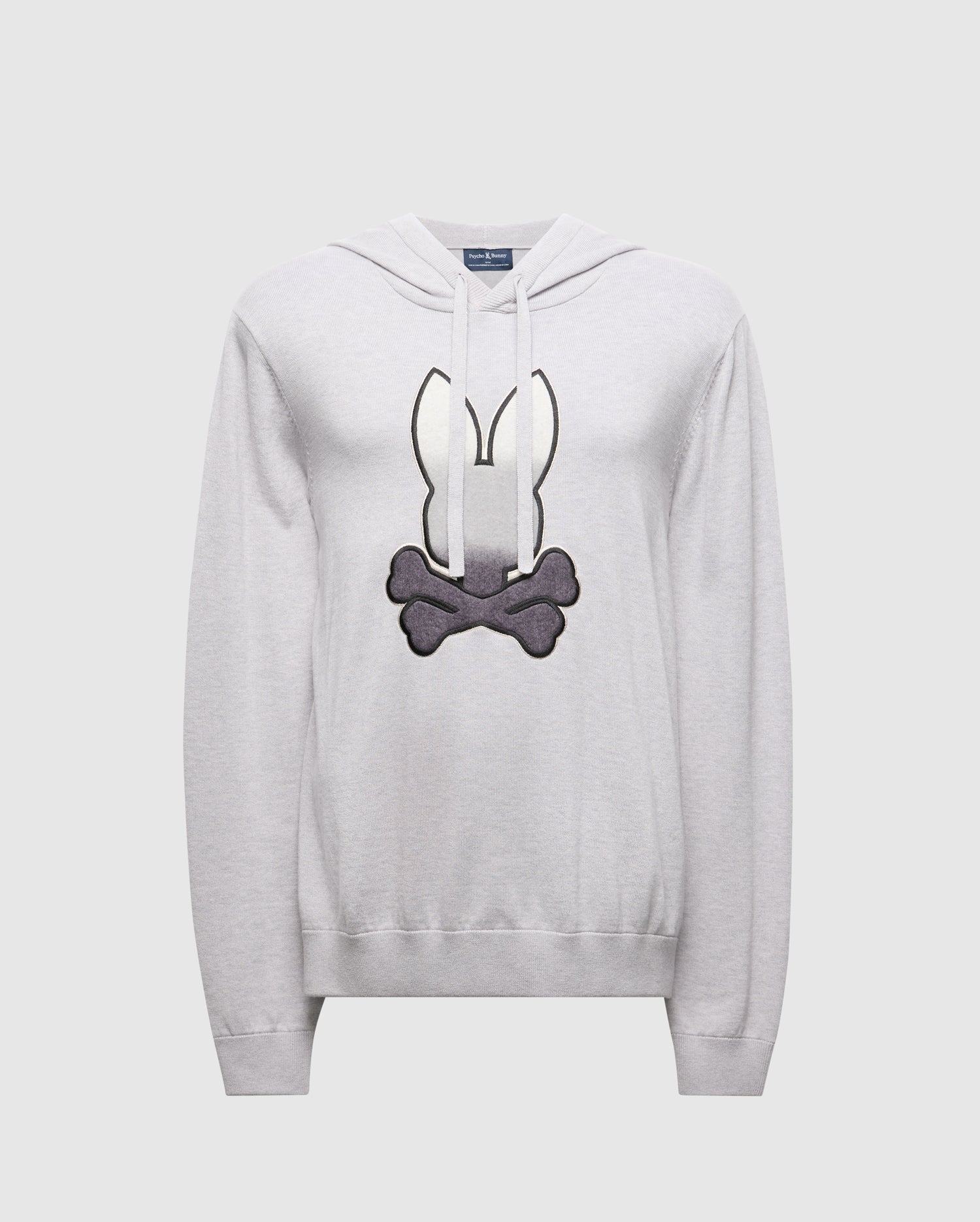The Psycho Bunny MENS BULDER HOODED SWEATER (B6E261E200) is crafted in light gray Supima Cotton, featuring a cartoon-style black and white emblem with bunny ears above crossed bones on the front, enhancing its premium quality against a plain background.