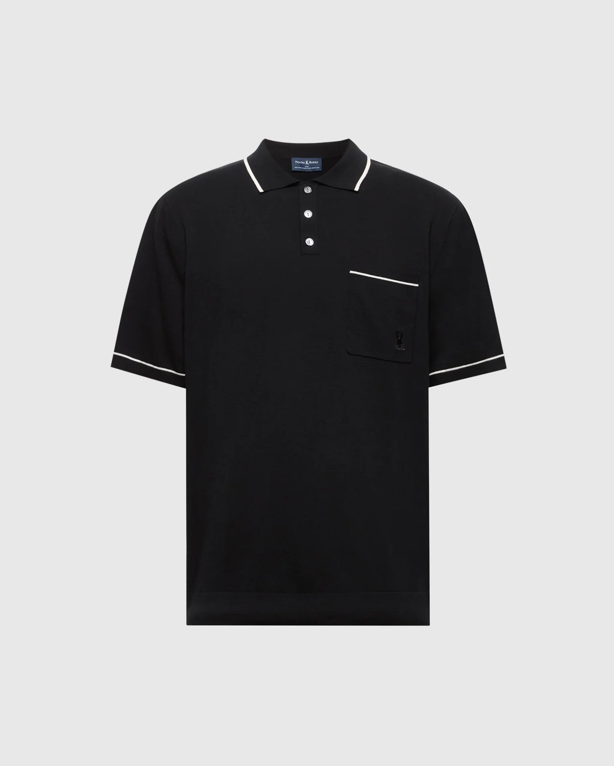 The Psycho Bunny MENS LONGFORD FINE KNIT POLO (B6E500F200) is a black short-sleeved shirt made of fine-knit cotton with white trim on the collar, sleeves, and pocket edge. It features an embroidered chest pocket on the left side and a three-button placket against a plain light gray background.