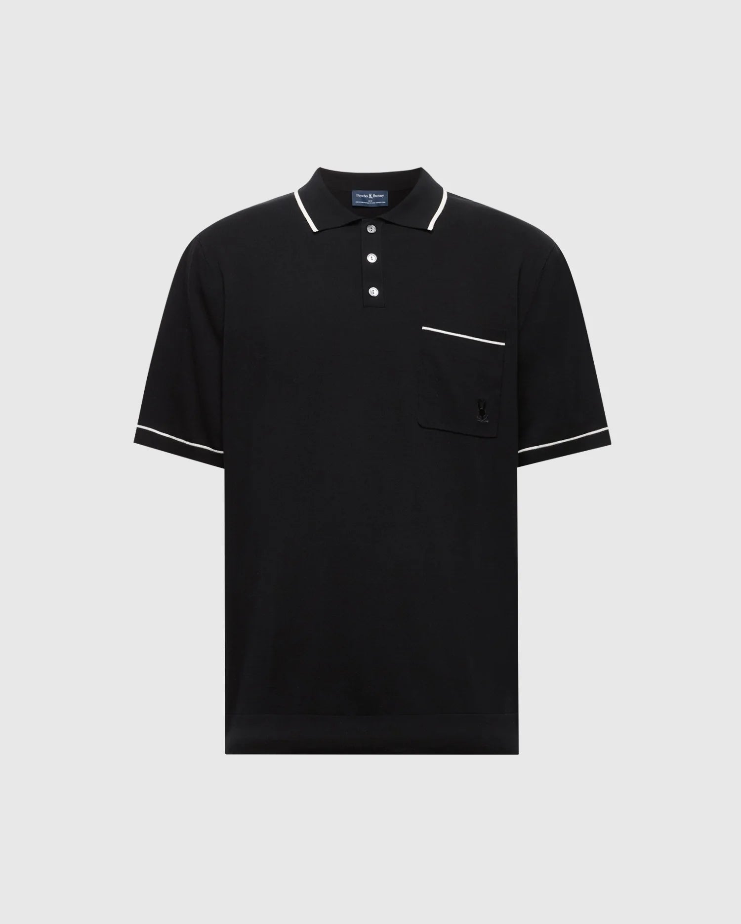 The Psycho Bunny MENS LONGFORD FINE KNIT POLO (B6E500F200) is a black short-sleeved shirt made of fine-knit cotton with white trim on the collar, sleeves, and pocket edge. It features an embroidered chest pocket on the left side and a three-button placket against a plain light gray background.