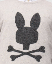 Here’s an up-close look at the Psycho Bunny MENS LINCOLN MERINO WOOL SWEATER (B6E831D200), offering a timeless style with its soft merino wool construction. It showcases a large, dark gray silhouette of a bunny's head with long ears, playfully mimicking the classic skull and crossbones design by featuring two crossed bones beneath it.