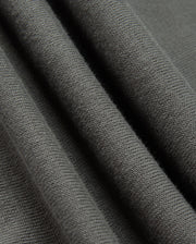 Close-up of the Psycho Bunny MENS BELMORE COTTON SWEATER - B6E832D200 in dark gray, highlighting its exquisite textured surface. The material exudes a soft and cozy feel, with delicate parallel lines that reveal the knit pattern and fabric thickness, capturing the luxurious essence of premium cotton craftsmanship.