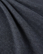 Close-up of the Psycho Bunny Men's Bradshaw Polo Sweater - B6E835D200, showcasing its dark gray fabric with a soft, smooth texture and gentle folds. The surface appears slightly fuzzy, indicating that this premium merino wool material is warm and comfortable, perfect for a luxury polo sweater.