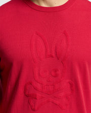 Close-up of a Psycho Bunny MENS COORY CHAINSTITCH COTTON SWEATER in red, showcasing an embossed bunny skull and crossbones design with intricate chainstitch embroidery on the front.