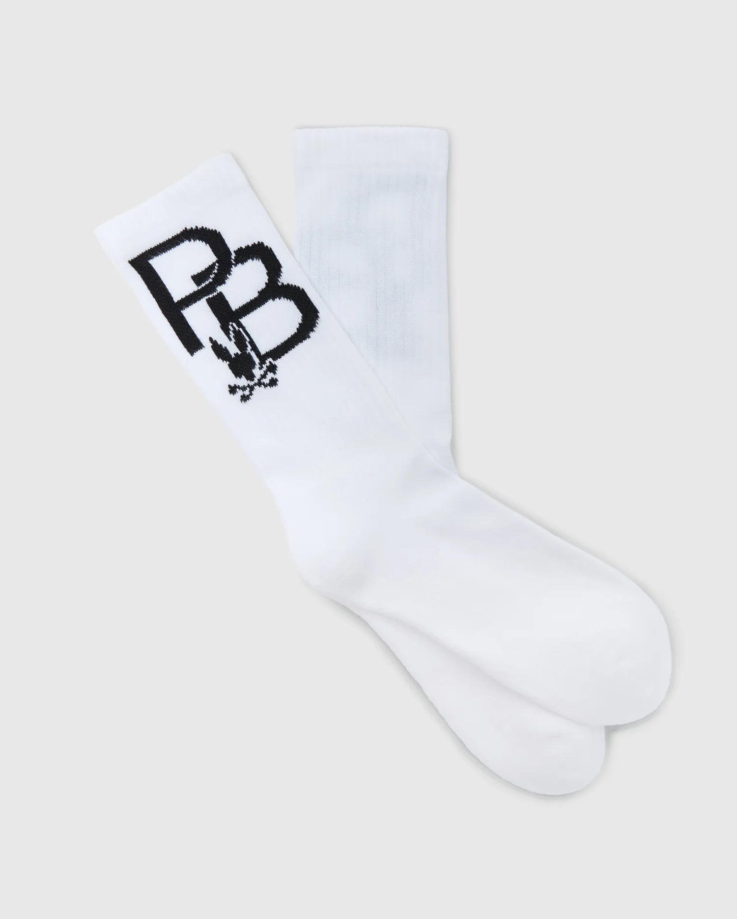 A pair of crew sport socks from the Psycho Bunny Men's Sport Sock Box Set (B6F268E200) for men, featuring bold black "PB" letters and a small graphic design near the top. Made from moisture-wicking Peruvian Pima cotton, these white socks are laid flat against a light gray background, highlighting their premium comfort and style.