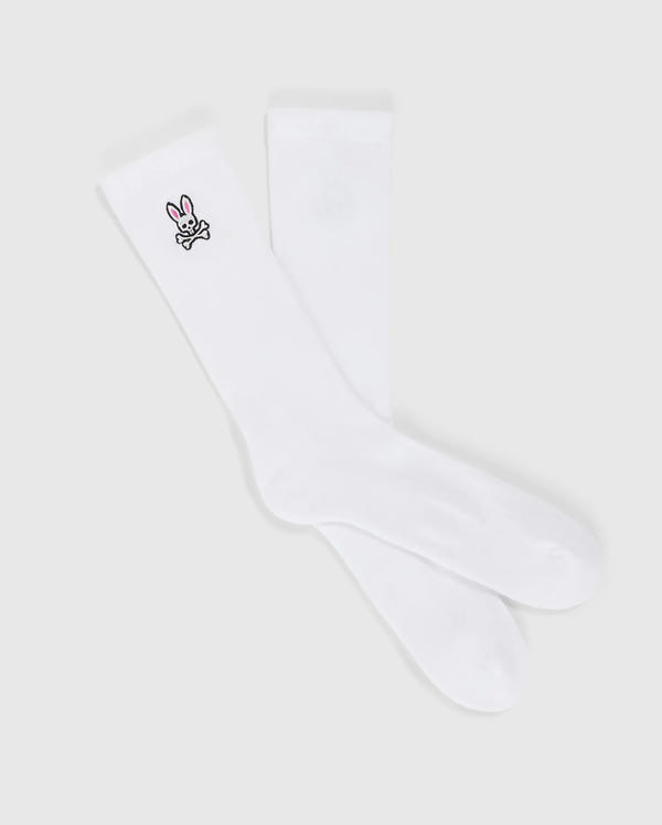 A pair of MENS FASHION SOCKS - B6F486C200 from Psycho Bunny, made from luxurious Pima cotton, featuring a small embroidered bunny design near the top. The bunny is depicted in black outline with a pink nose and ears, adorning only one sock. These stylish socks are made in Peru and offer both comfort and charm.