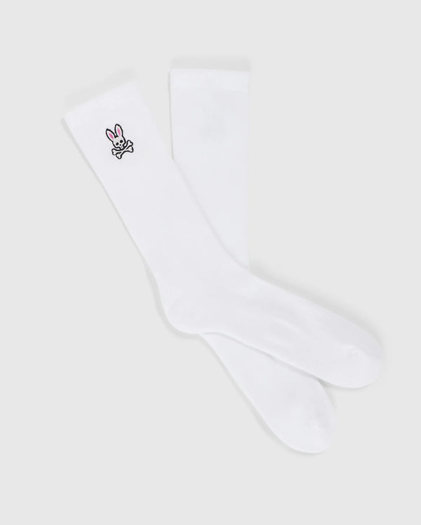A pair of MENS FASHION SOCKS - B6F486C200 from Psycho Bunny, made from luxurious Pima cotton, featuring a small embroidered bunny design near the top. The bunny is depicted in black outline with a pink nose and ears, adorning only one sock. These stylish socks are made in Peru and offer both comfort and charm.