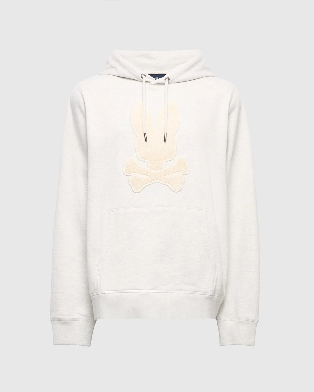 The Psycho Bunny MENS ELDORADO BRUSH BACK HOODIE (B6H234E200) is a cozy light gray, featuring a beige embroidered skull and crossbones with bunny ears, brush-back comfort, front pocket, and hood drawstrings—ideal for swaddle season style.