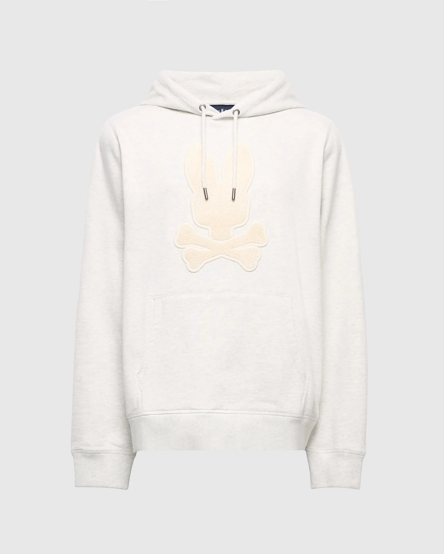 The Psycho Bunny MENS ELDORADO BRUSH BACK HOODIE (B6H234E200) is a cozy light gray, featuring a beige embroidered skull and crossbones with bunny ears, brush-back comfort, front pocket, and hood drawstrings—ideal for swaddle season style.