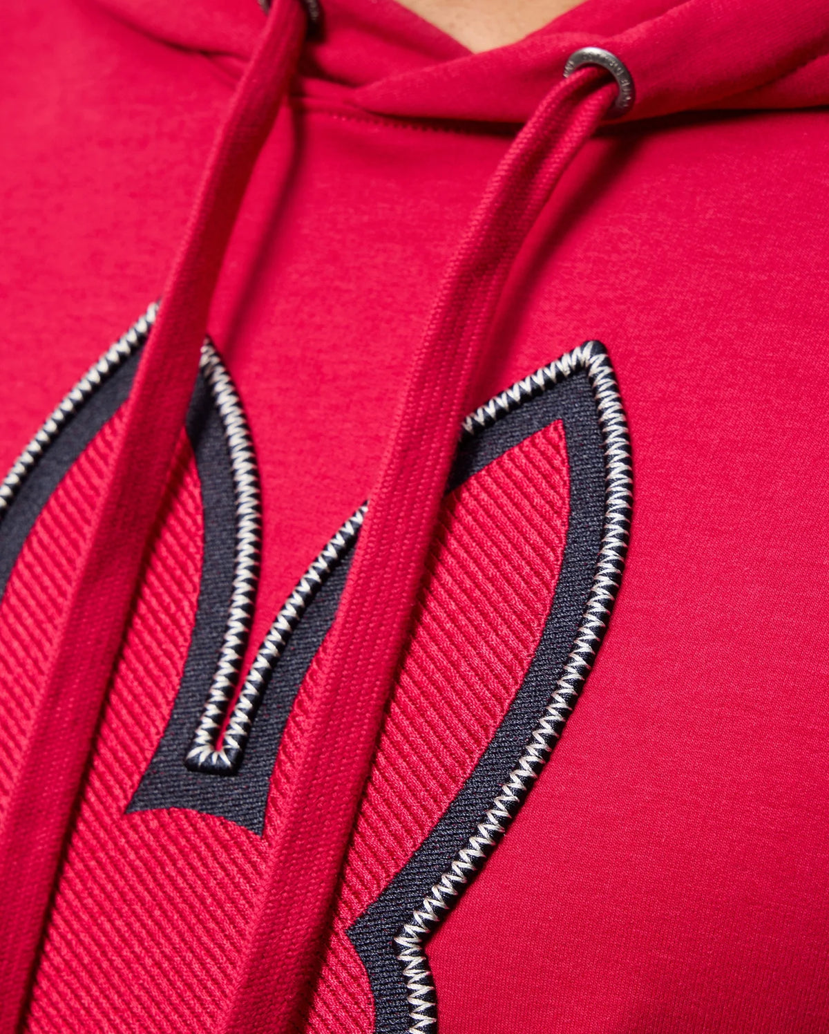 Close-up of the red MENS WALTER LIGHTWEIGHT HOODIE by Psycho Bunny, showcasing 3D outlined bunny ears embroidery on the front. The hoodie strings and stitching details are prominently visible.