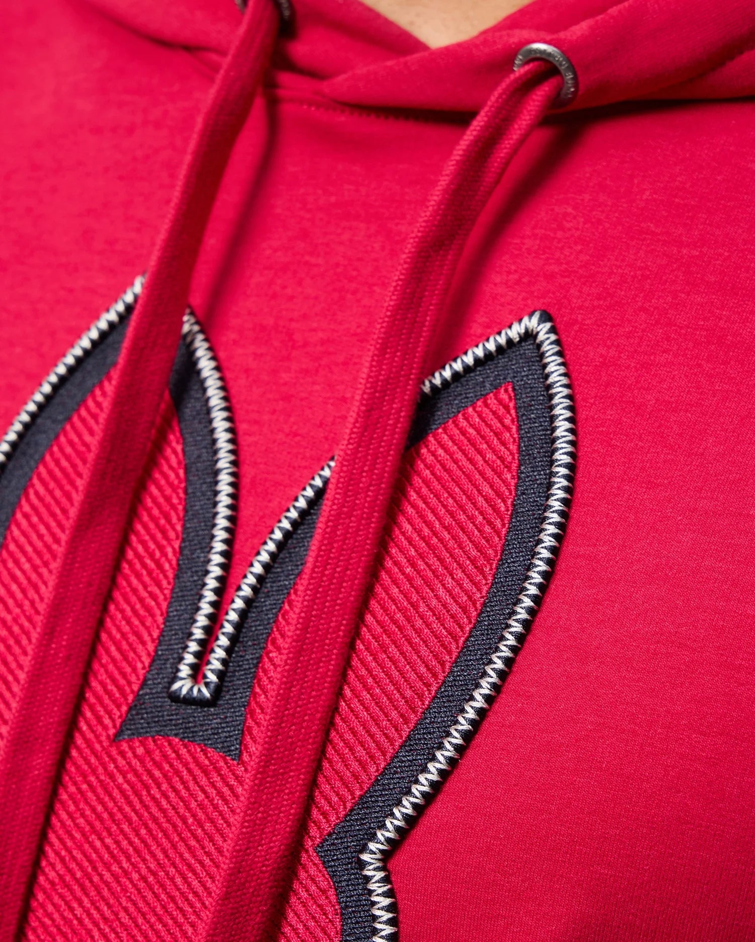Close-up of the red MENS WALTER LIGHTWEIGHT HOODIE by Psycho Bunny, showcasing 3D outlined bunny ears embroidery on the front. The hoodie strings and stitching details are prominently visible.