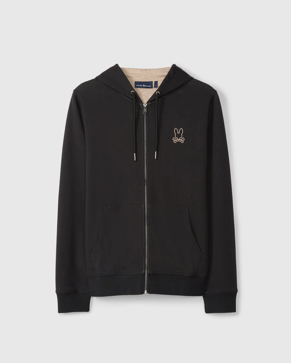 The MENS JAMES PREMIUM ZIP HOODIE - B6H793D200 by Psycho Bunny features a small embroidered Bunny graphic on the left chest, with crossed bones below it. Made from double-faced premium jersey, it includes front pockets, a drawstring hood, and ribbed cuffs and hem. Displayed against a plain white background.
