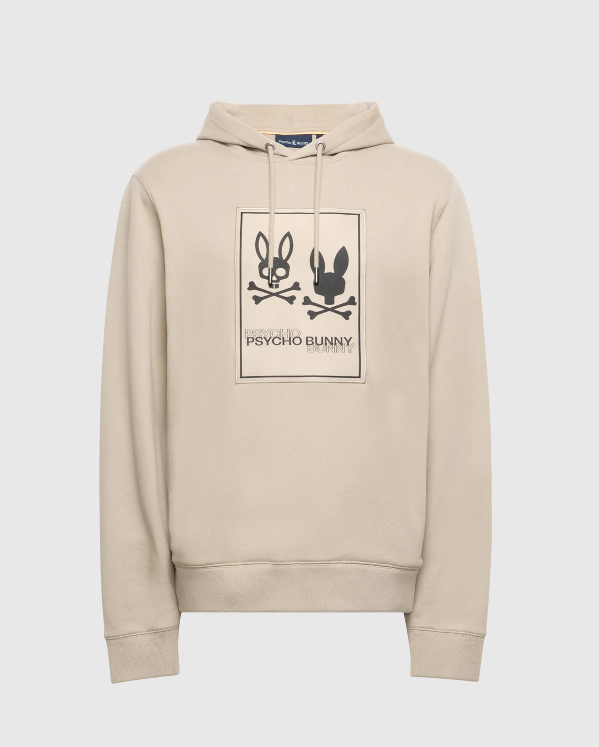 Enjoy the comfort of the Psycho Bunny Men's Monroe Twill Patch Fleece Hoodie, crafted from French terry. It showcases a graphic print with two stylized bunny faces over crossed bones in a rectangle, complete with tonal accents and "Psycho Bunny" branding.