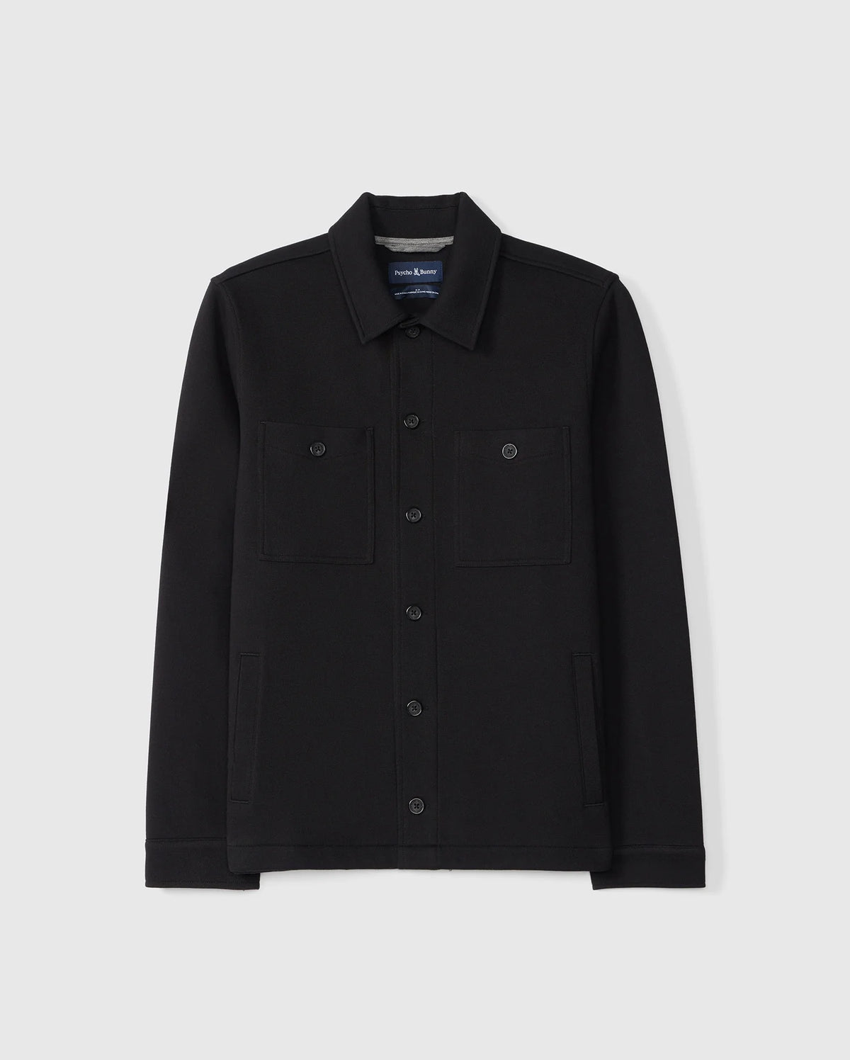The Psycho Bunny MENS BEDFORD SHIRT JACKET - B6J290B200 in black, highlighted with two chest pockets and a classic collar, is displayed against a plain white background.