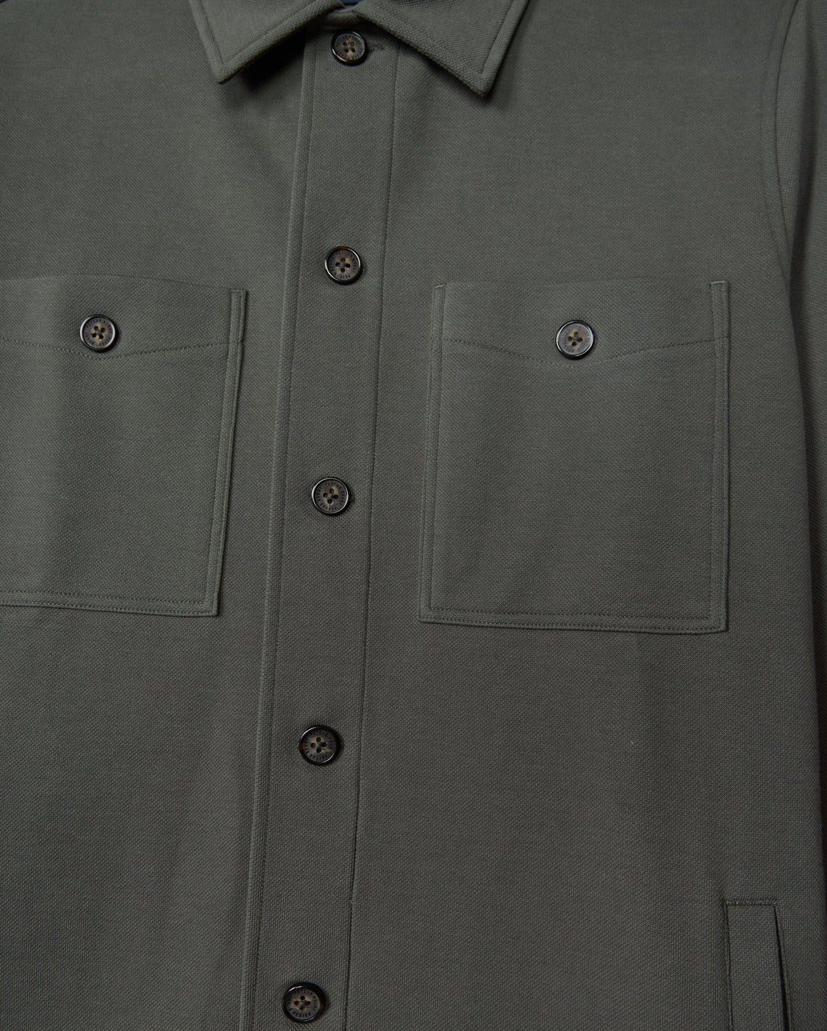 The Psycho Bunny MENS BEDFORD SHIRT JACKET - B6J290B200 in a dark green cotton-blend exudes an urban vibe, boasting two chest pockets and refined black buttons.