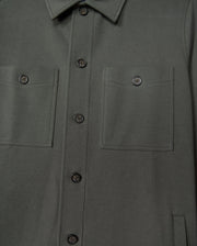The Psycho Bunny MENS BEDFORD SHIRT JACKET - B6J290B200 in a dark green cotton-blend exudes an urban vibe, boasting two chest pockets and refined black buttons.