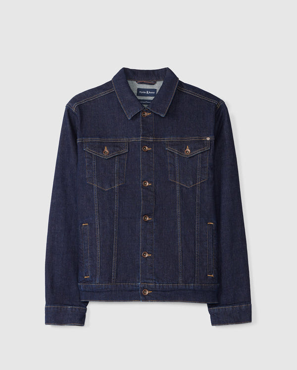 Introducing the Psycho Bunny MENS PATHE DENIM JACKET - B6J741X1CO: This classic men's dark blue denim jacket showcases a pointed collar and button-down design. It features two chest pockets with buttoned flaps, embroidered details, and contrast stitching for an adjustable fit, all presented against a plain white background.