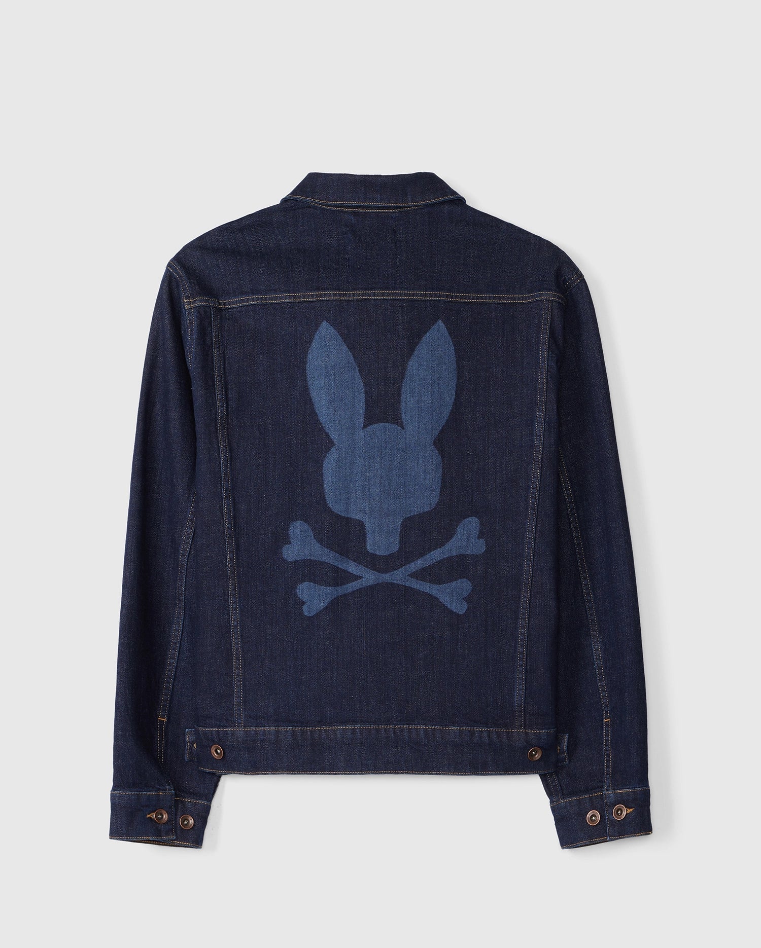 Introducing the Men's Pathe Denim Jacket by Psycho Bunny (Model: B6J741X1CO) in a dark wash. This jacket showcases detailed embroidery with a bold silhouette of a rabbit head above crossed bones on the back. It features button cuffs, a classic collar, and an adjustable fit for personalized comfort.