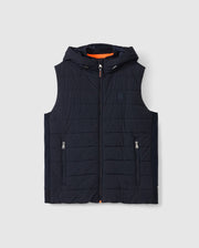 The Psycho Bunny MENS MALCOLM MIXED MEDIA VEST (B6J861D200) is a black quilted vest with a hood, front zipper, and two zippered pockets. Its orange lining adds a stylish contrast against the plain white background.