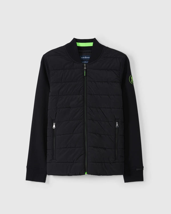 Introducing the MENS MYKEL MIXED MEDIA JACKET - B6J875D200 by Psycho Bunny. This versatile black jacket combines a quilted front with solid sleeves and includes a convenient front zipper along with two zippered pockets. Featuring a circular logo patch on the left sleeve, this stylish men's jacket is beautifully showcased against a light gray background.