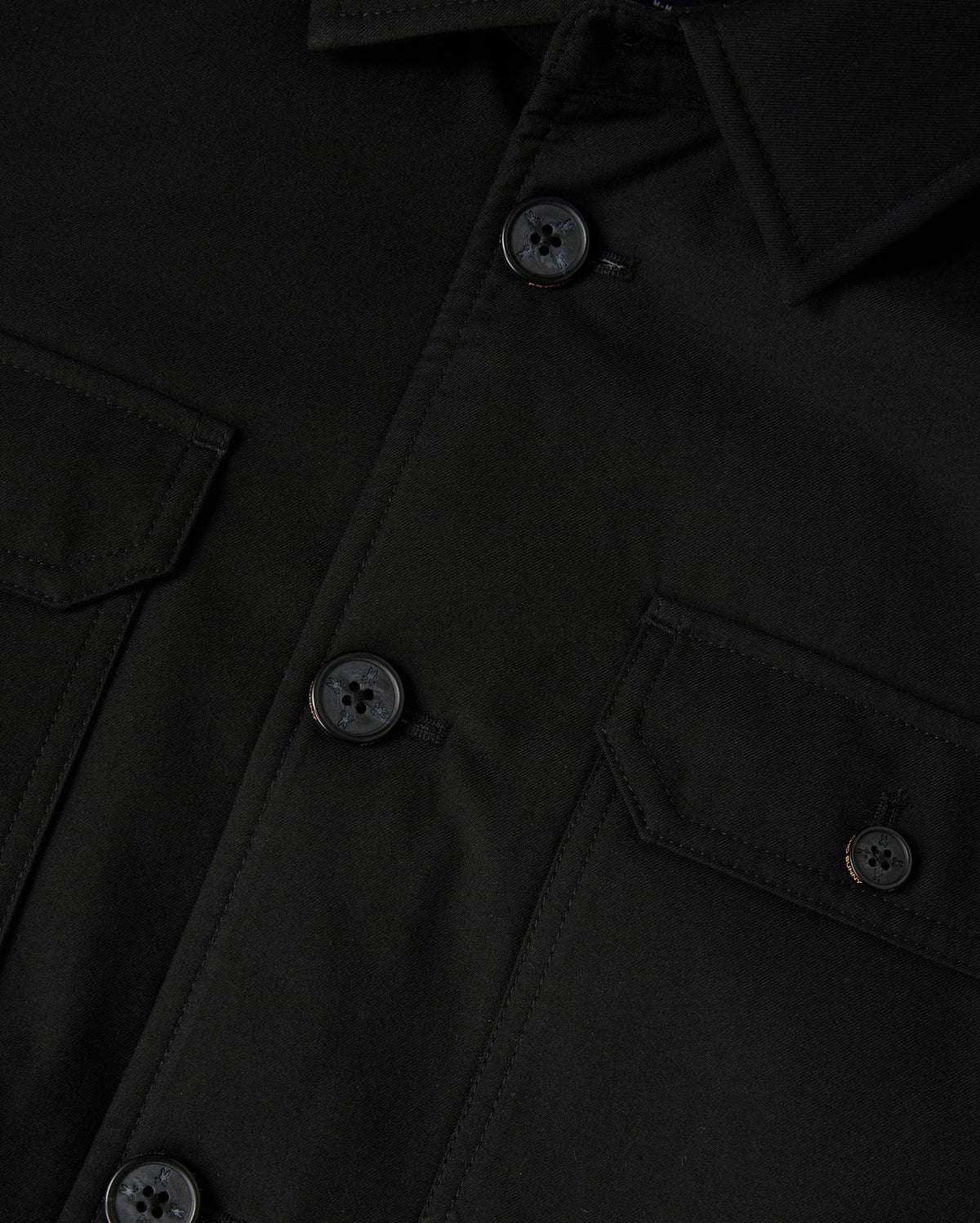 The Psycho Bunny Men's Hillcrest Padded Shacket (B6J936D200) features a black fabric with a collar, buttoned front, and two chest flap pockets with buttons. The neon lining adds vibrancy, while the textured fabric and detailed stitching are prominently showcased.