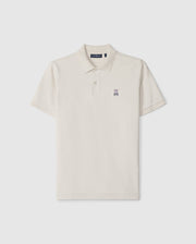 A timeless men's classic pique polo in luxurious Pima cotton, this plain, short-sleeved shirt in off-white features a collar, two buttons, and a small embroidered bunny logo on the left chest. The product is the MENS CLASSIC PIQUE POLO SHIRT - B6K001B200 by Psycho Bunny.