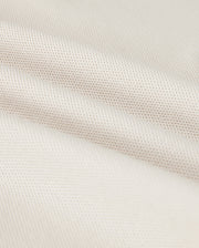 Close-up of a softly folded, light beige textured fabric with a subtle grid pattern, showcasing its smooth and pliable nature. The gentle folds add depth and highlight the luxurious Pima cotton's fine weave and soft sheen, hinting at the perfect fit for a Psycho Bunny Men's Classic Pique Polo Shirt - B6K001B200.