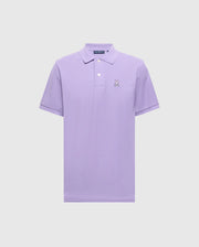 The Psycho Bunny Men's Classic Pique Polo (B6K001Z1PC) in lavender, made of soft Pima cotton, features short sleeves, a collar, and a buttoned placket. It showcases an embroidered cartoon Bunny logo on the left chest against a plain light background.