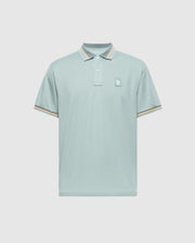 MENS STRATTON SPORT PIQUE POLO by Psycho Bunny features moisture-wicking light blue fabric, short sleeves, and a small embroidered logo on the left chest. The collar and sleeve cuffs have subtle beige and white stripes. Displayed against a plain, light gray background.