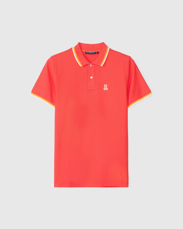The Psycho Bunny MENS GRANBURY PIQUE POLO - B6K400C200 is a red Pima cotton polo shirt with a yellow rib knit collar and sleeve trim, featuring a small white embroidered rabbit logo on the left chest against a plain white background.